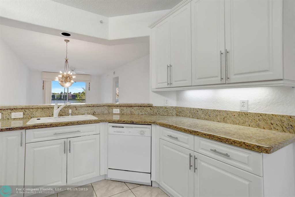 7727 Southampton Terrace, Unit 205 Tamarac, FL 33321 - Photo 16 of 36 a kitchen with white cabinets appliances a sink and dishwasher