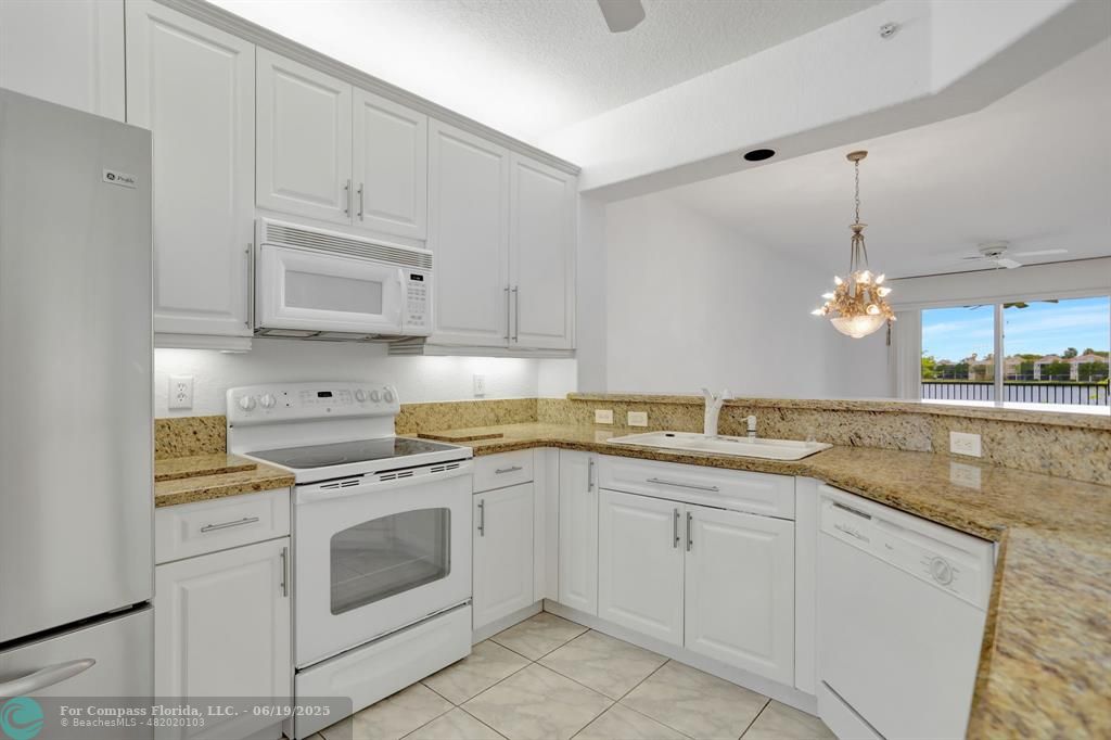 7727 Southampton Terrace, Unit 205 Tamarac, FL 33321 - Photo 2 of 36 a kitchen with white cabinets stainless steel appliances and a sink