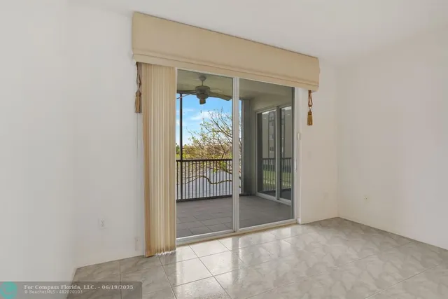 an empty room with cabinet and mirrors