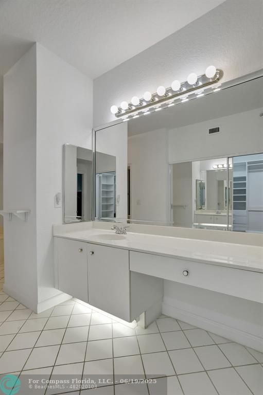 7727 Southampton Terrace, Unit 205 Tamarac, FL 33321 - Photo 26 of 36 a spacious bathroom with a mirror and a chandelier