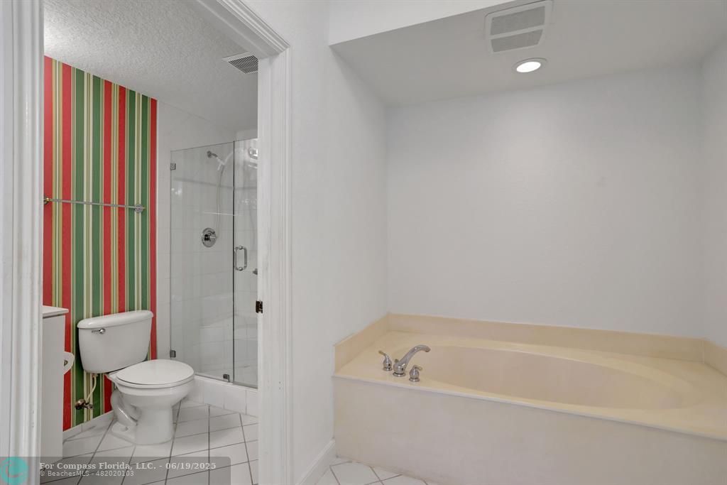 7727 Southampton Terrace, Unit 205 Tamarac, FL 33321 - Photo 27 of 36 a bathroom with a toilet a sink and bathtub