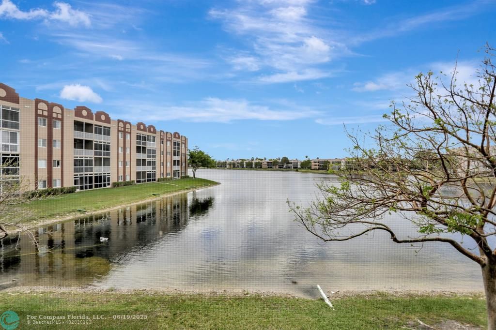 7727 Southampton Terrace, Unit 205 Tamarac, FL 33321 - Photo 33 of 36 a view of a lake with building in front of it
