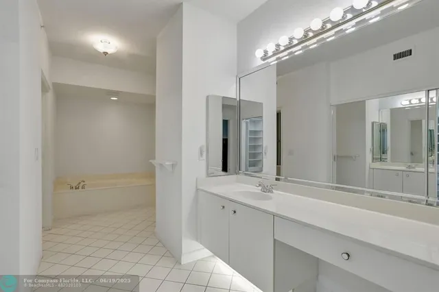 a bathroom with a sink shower and a mirror