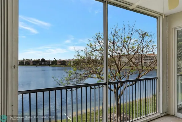 a view of a balcony with wooden fence and floor