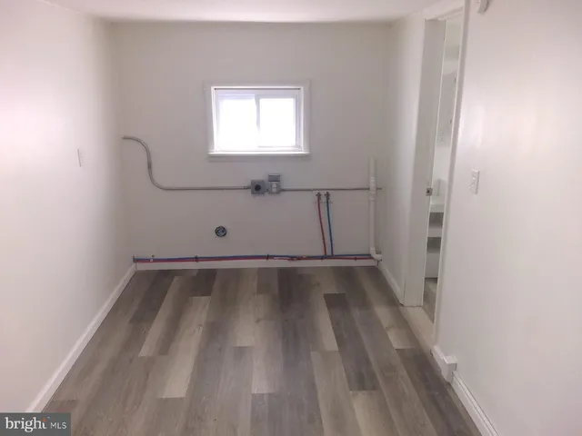 a view of a room with wooden floor and window