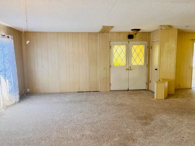 a view of an empty room and a window