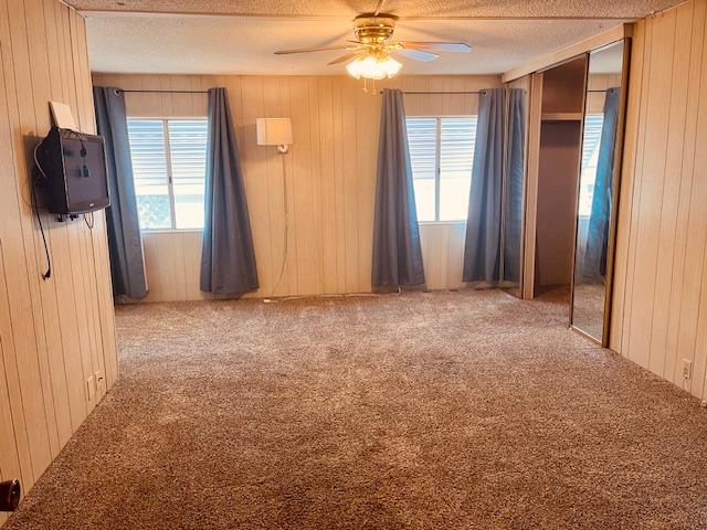 2706 West Ashlan Avenue, Unit 329 Fresno, CA 93705 - Photo 16 of 43 a view of an empty room with a fireplace and a window