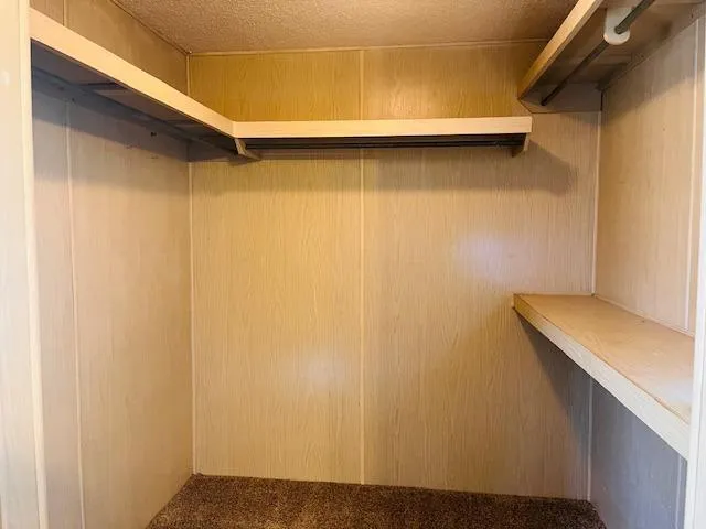 a bathroom with a shower a toilet and a glass door