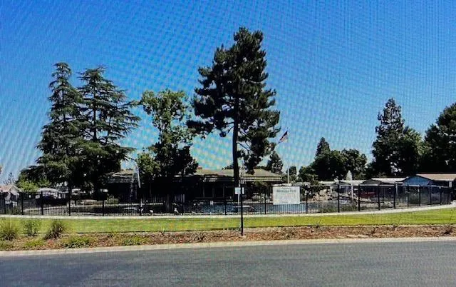 a backyard of a house with table and chairs