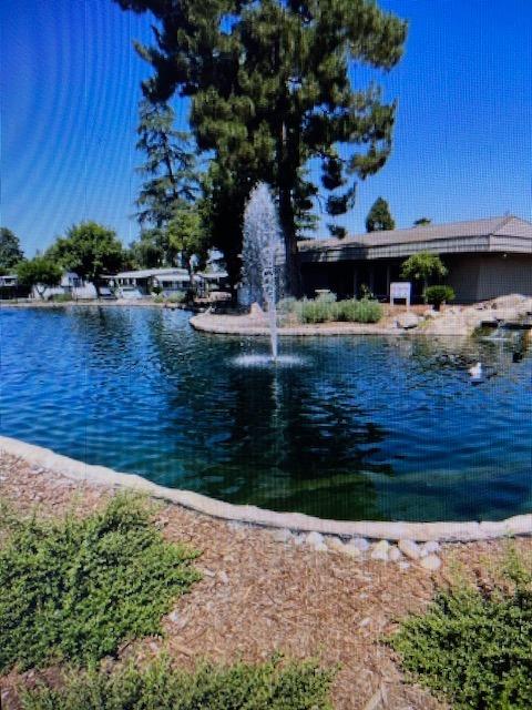 2706 West Ashlan Avenue, Unit 329 Fresno, CA 93705 - Photo 28 of 43 a wooden bench sitting in front of a building