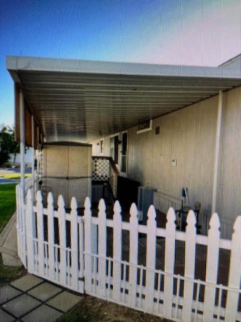 2706 West Ashlan Avenue, Unit 329 Fresno, CA 93705 - Photo 4 of 43 a view of a house with wooden fence