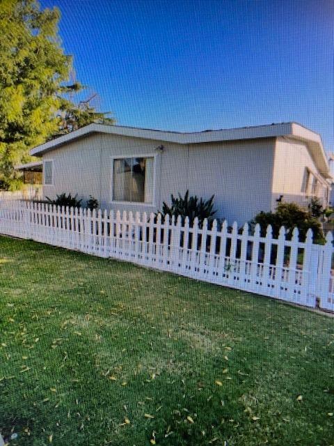 2706 West Ashlan Avenue, Unit 329 Fresno, CA 93705 - Photo 5 of 43 a view of a house with a yard