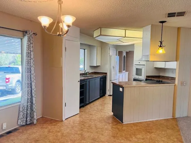 a kitchen with stainless steel appliances granite countertop a stove and a refrigerator