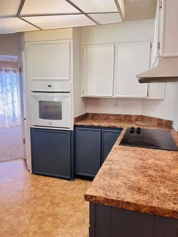 a kitchen with granite countertop a stove and a sink