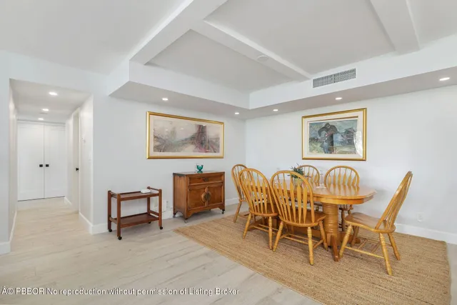 a dining room with furniture a window and wooden floor
