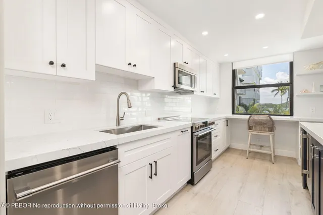 a large kitchen with a sink and cabinets