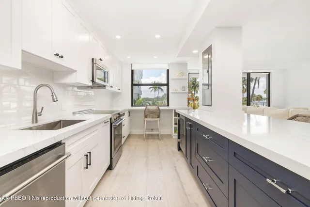 a kitchen with stainless steel appliances white cabinets and a stove