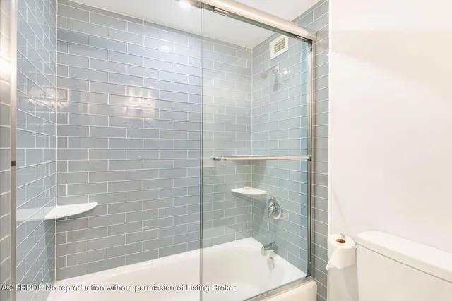 a bedroom with a large bed and a large window