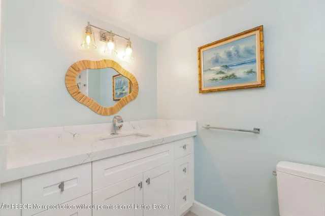 a bedroom with a balcony a bed and a painting on the wall