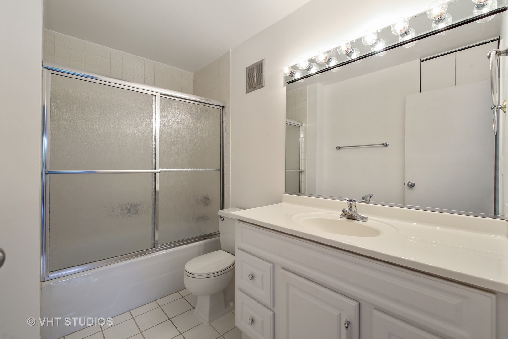 1615 East Central Road, Unit 417C Arlington Heights, IL 60005 - Photo 12 of 23 a bathroom with a shower sink vanity mirror and toilet