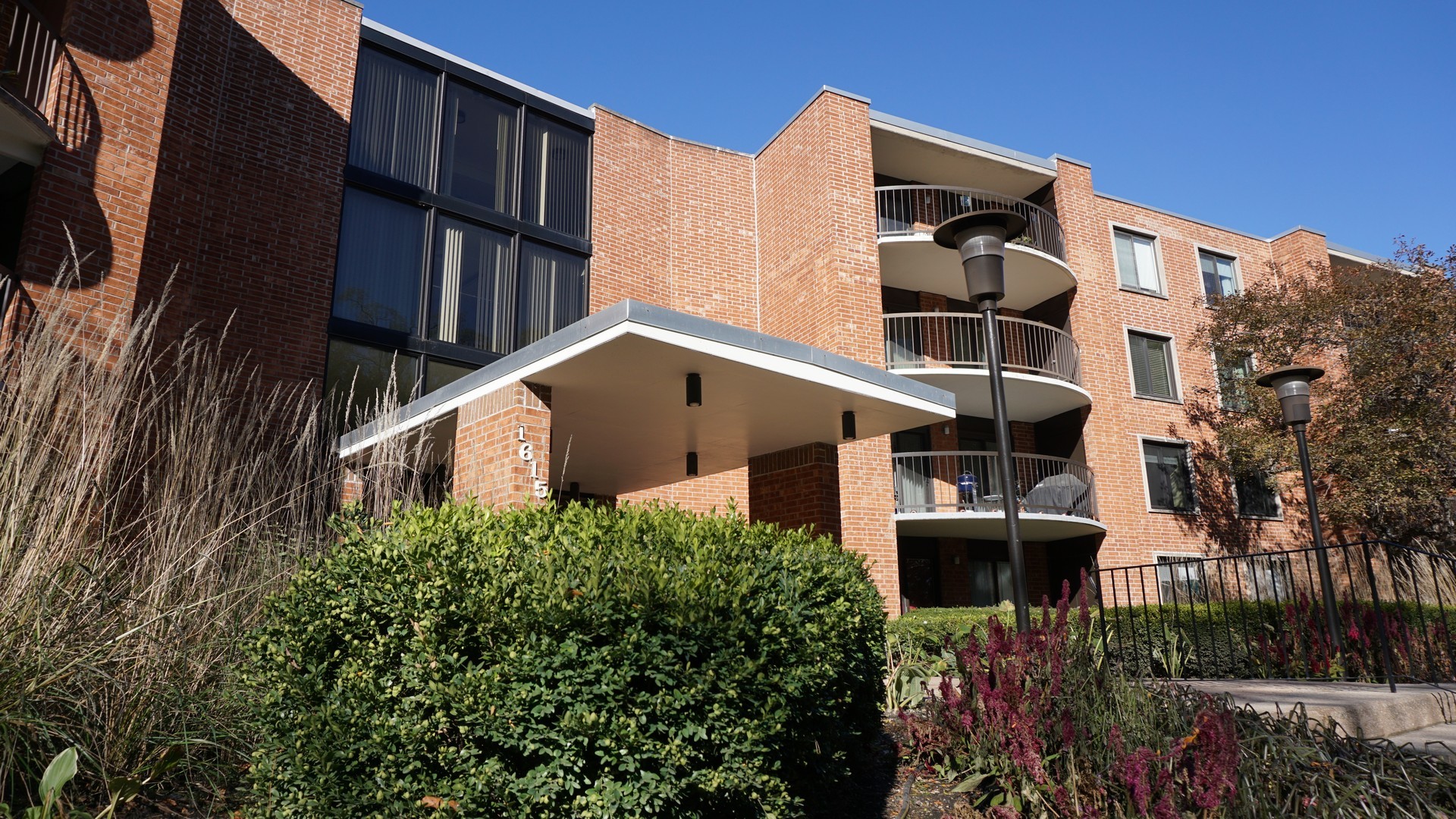 1615 East Central Road, Unit 417C Arlington Heights, IL 60005 - Photo 21 of 23 front view of building with a yard