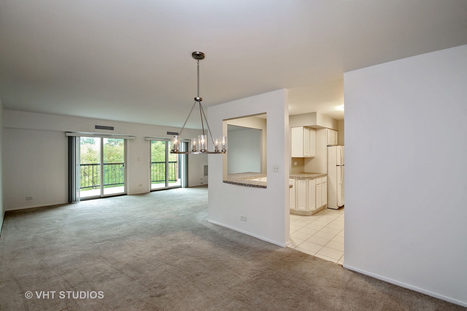 1615 East Central Road, Unit 417C Arlington Heights, IL 60005 - Photo 7 of 23 a view of empty room with a fireplace