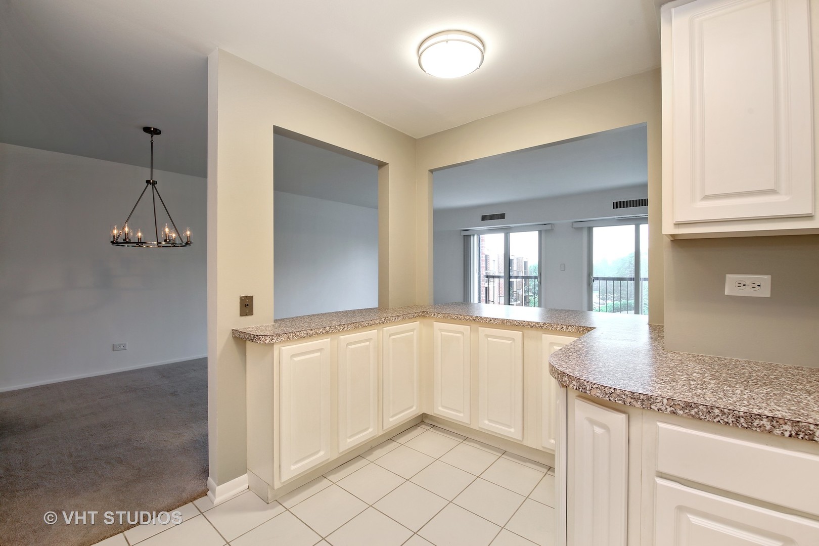 1615 East Central Road, Unit 417C Arlington Heights, IL 60005 - Photo 9 of 23 a kitchen with granite countertop cabinets and window