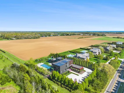 a view of a patio with table and chairs potted plants and large tree
