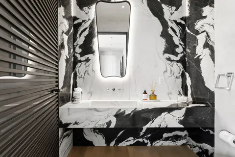 a living room with lots of furniture and a chandelier