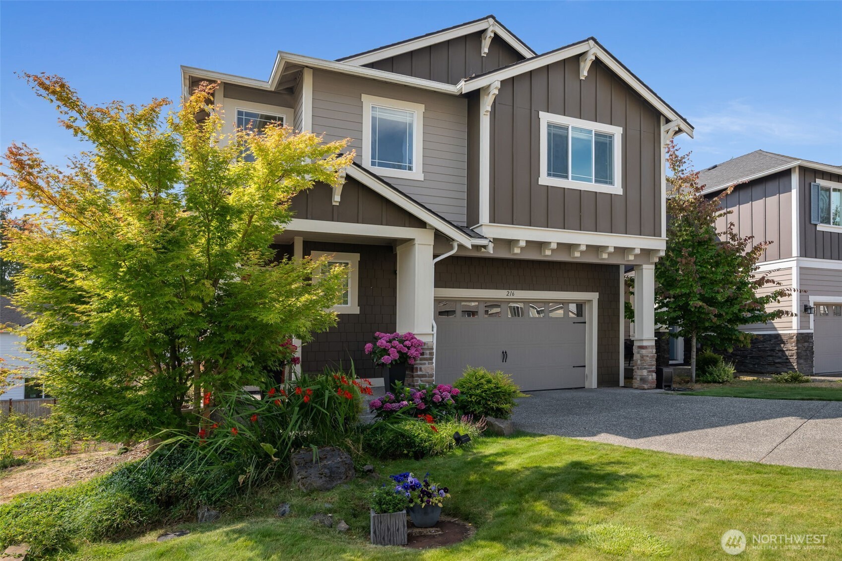 216 178th Street Southeast Bothell, WA 98012 - Photo 2 of 40 a front view of a house with a garden
