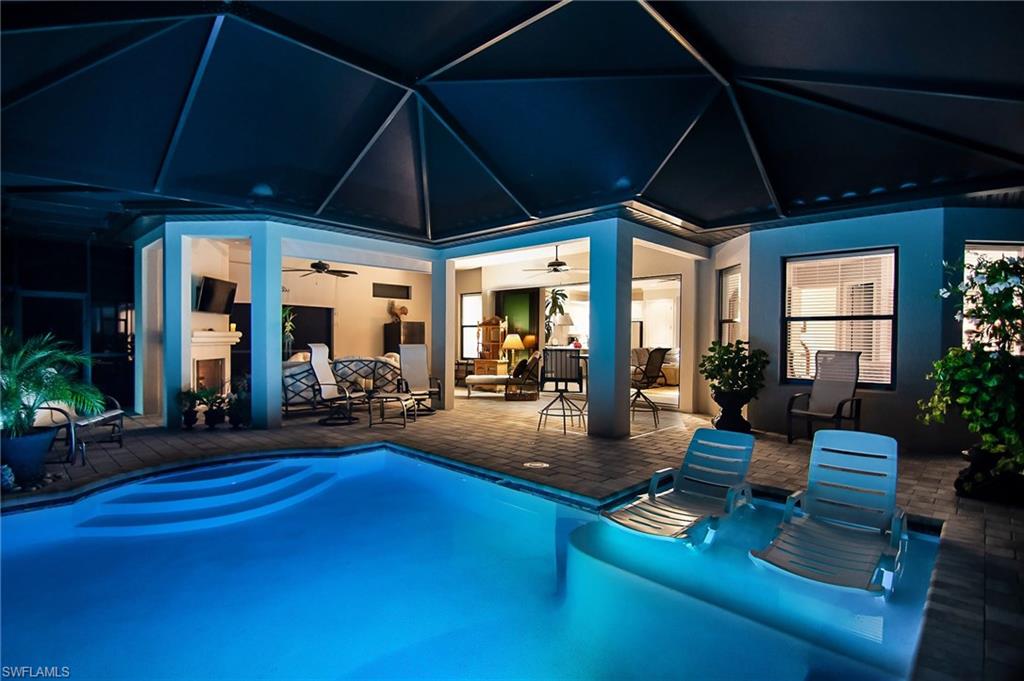 10249 Coconut Road Estero, FL 34135 - Photo 1 of 27 a view of a patio with table and chairs under an umbrella