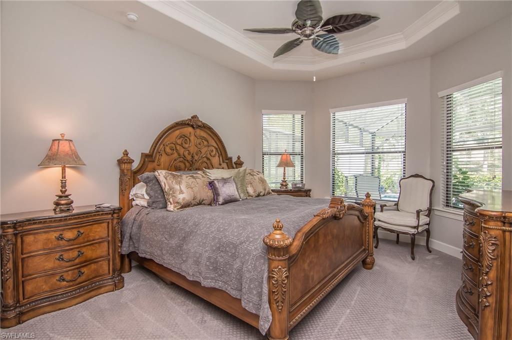 10249 Coconut Road Estero, FL 34135 - Photo 15 of 27 a bedroom with a bed and wooden floor