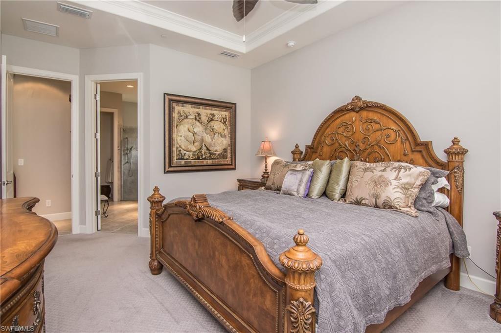 10249 Coconut Road Estero, FL 34135 - Photo 16 of 27 a bedroom with a bed and wooden floor