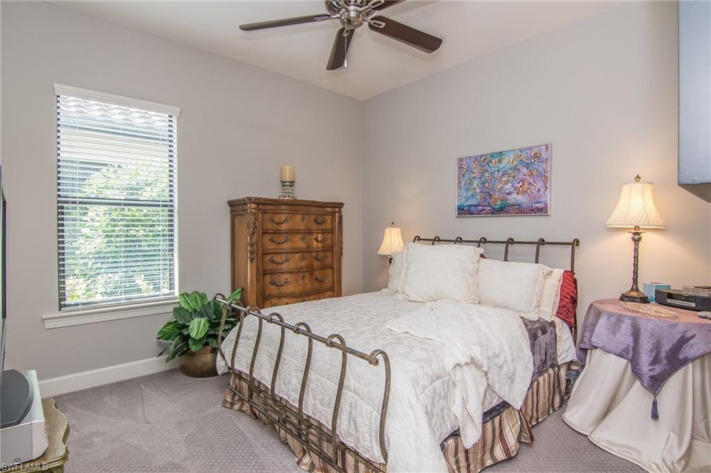 10249 Coconut Road Estero, FL 34135 - Photo 19 of 27 a bedroom with a bed and furniture
