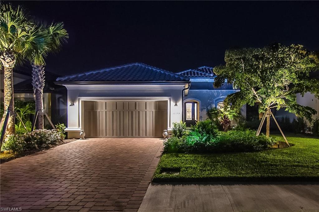 10249 Coconut Road Estero, FL 34135 - Photo 2 of 27 a front view of a house with garden