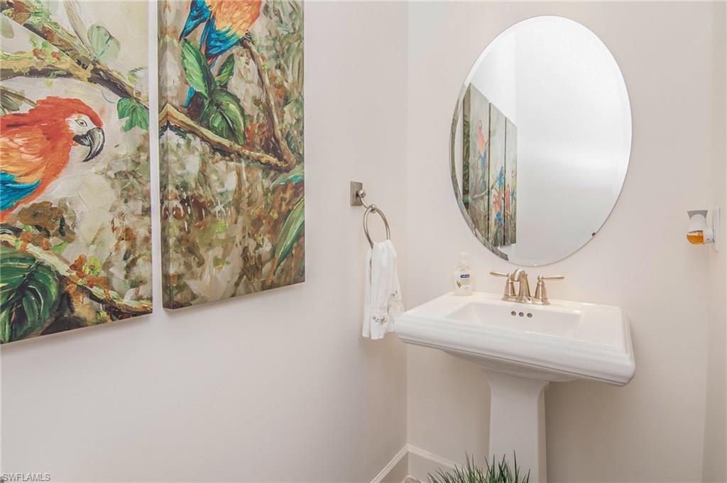 10249 Coconut Road Estero, FL 34135 - Photo 22 of 27 a bathroom with a sink and a mirror