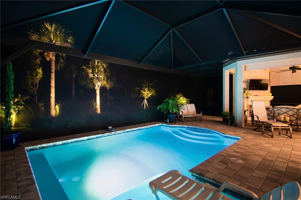 10249 Coconut Road Estero, FL 34135 - Photo 23 of 27 a backyard of a house with yard fire pit and outdoor seating