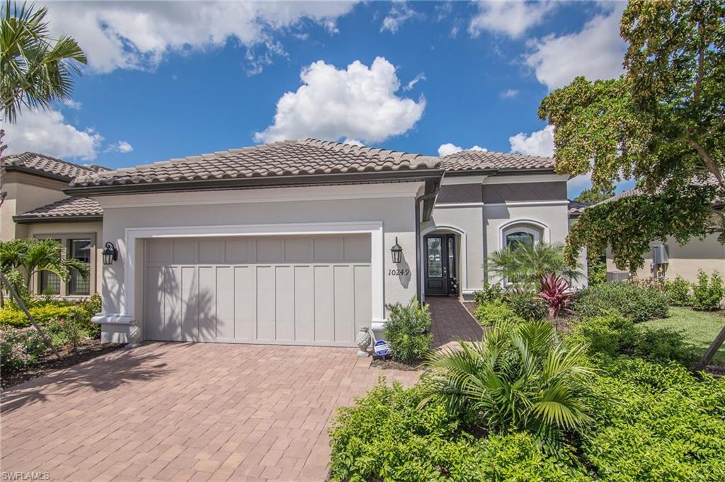 10249 Coconut Road Estero, FL 34135 - Photo 4 of 27 front view of a house with potted plants