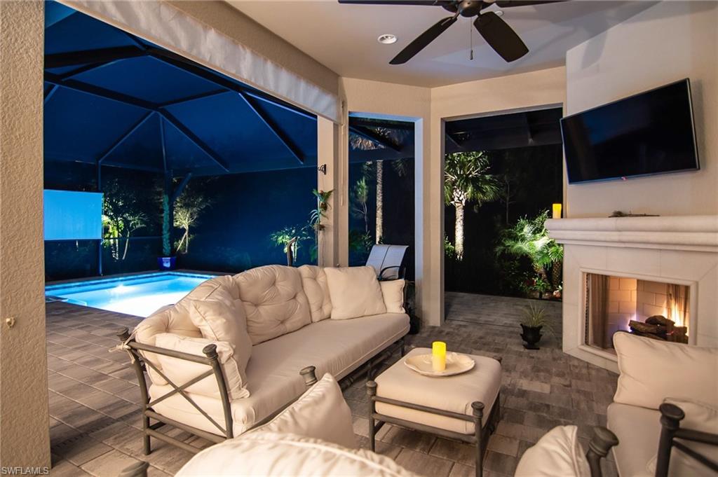 10249 Coconut Road Estero, FL 34135 - Photo 6 of 27 a living room with furniture and a flat screen tv