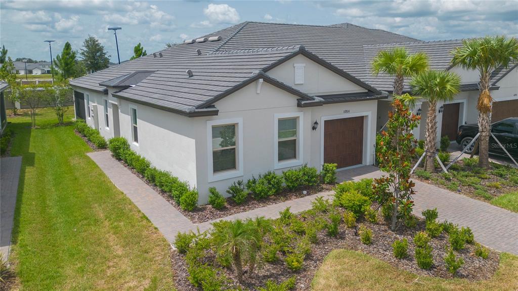 10806 Gable Dig Loop San Antonio, FL 33576 - Photo 46 of 73 a aerial view of a house with a yard and potted plants