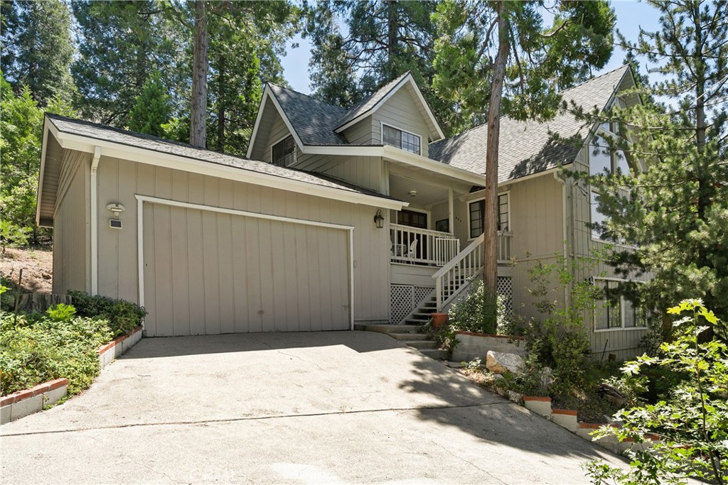 329 Grass Valley Road Lake Arrowhead, CA 92352 - Photo 6 of 31 a front view of a house with a garden