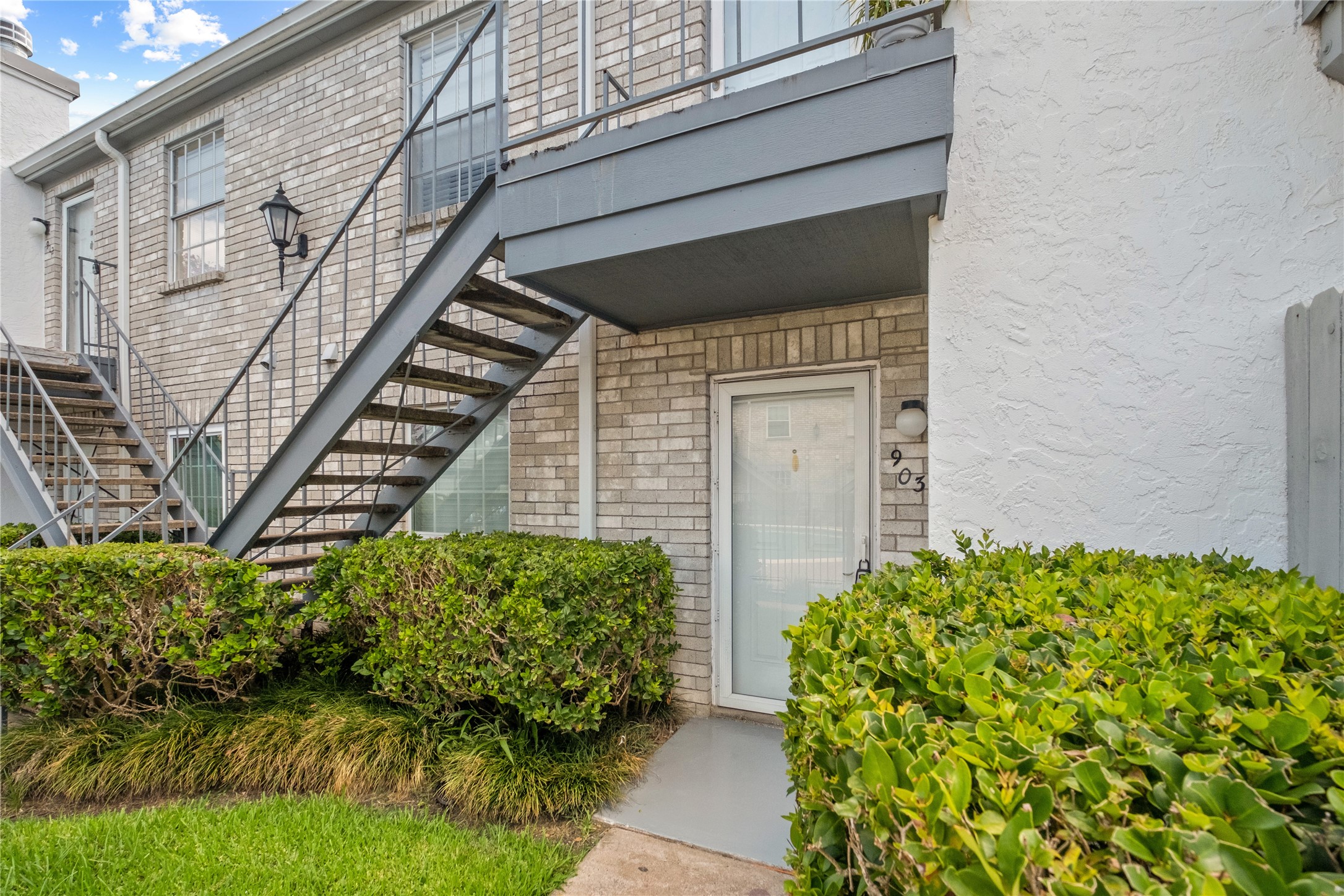 8787 Brae Acres Road, Unit 903 Houston, TX 77074 - Photo 12 of 15 a front view of a house with a yard