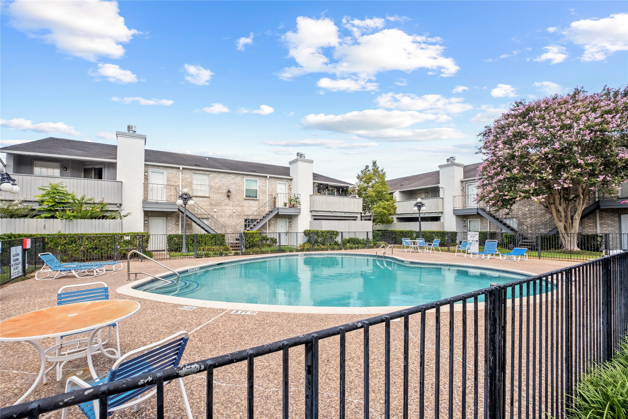 8787 Brae Acres Road, Unit 903 Houston, TX 77074 - Photo 13 of 15 a view of a swimming pool with a patio and a yard