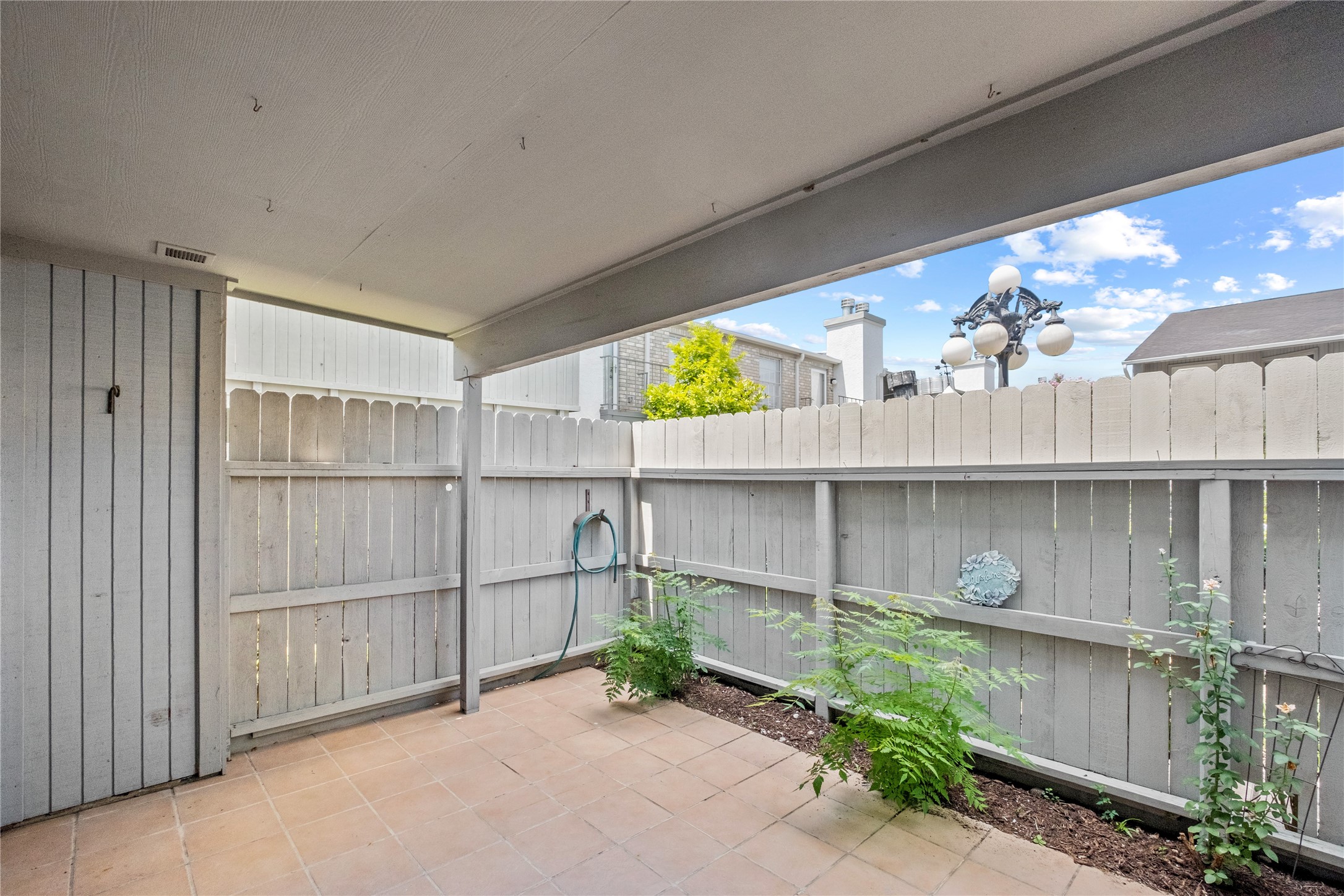 8787 Brae Acres Road, Unit 903 Houston, TX 77074 - Photo 14 of 15 a backyard of a house with wooden floor