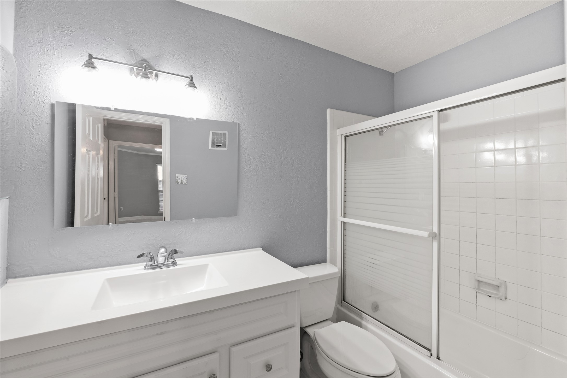 8787 Brae Acres Road, Unit 903 Houston, TX 77074 - Photo 4 of 15 a bathroom with a sink toilet vanity and shower