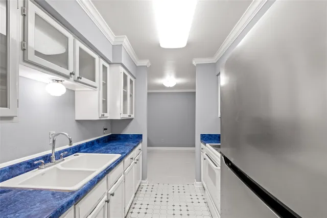 a bathroom with a granite countertop double vanity sink a mirror and a bathtub