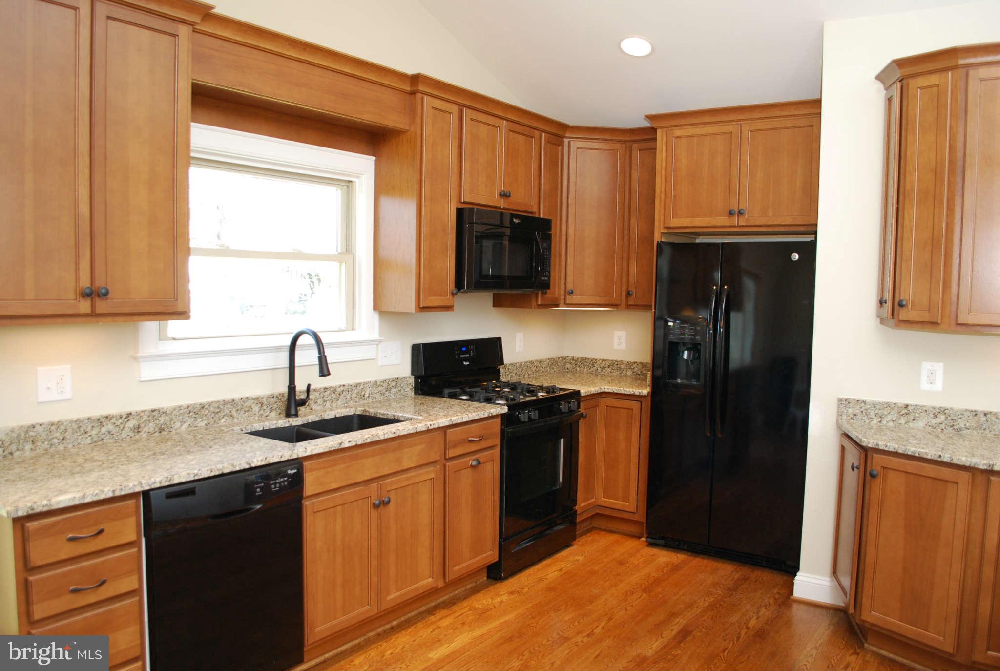 6020 Frontier Drive Springfield, VA 22150 - Photo 2 of 12 a kitchen with a sink stove and refrigerator