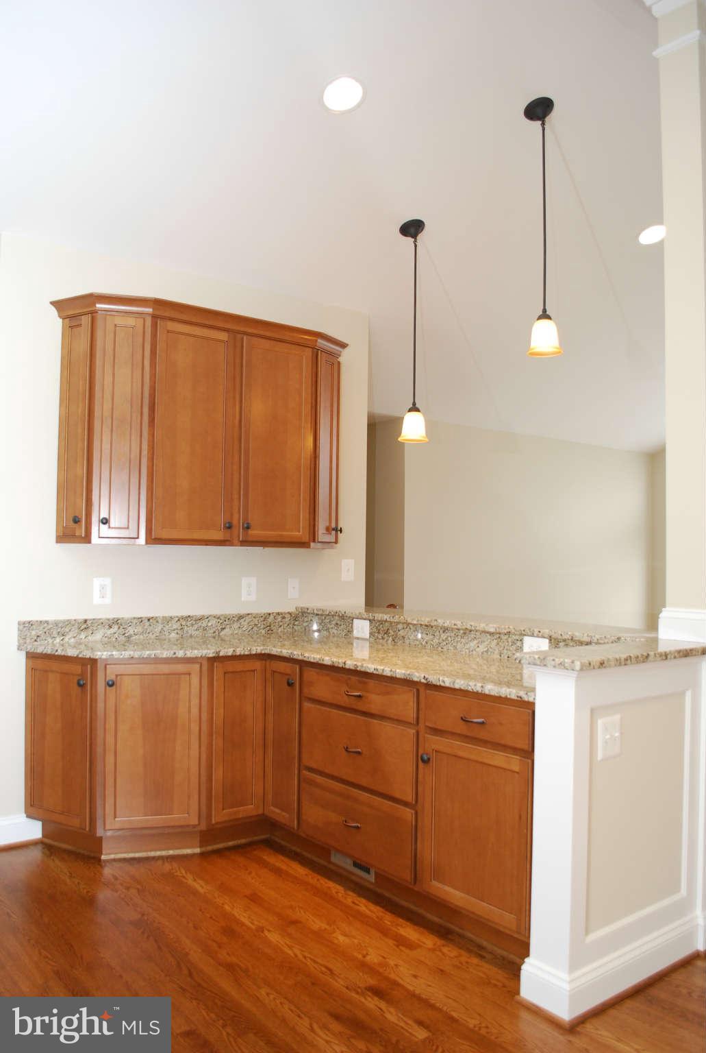 6020 Frontier Drive Springfield, VA 22150 - Photo 3 of 12 a kitchen with a sink cabinets and wooden floor