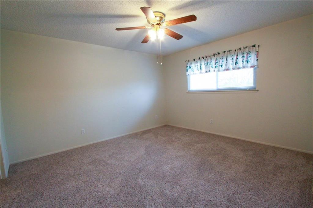 12902 Old San Antonio Road, Unit A Manchaca, TX 78652 - Photo 6 of 9 Carpeted room with a window and ceiling fan