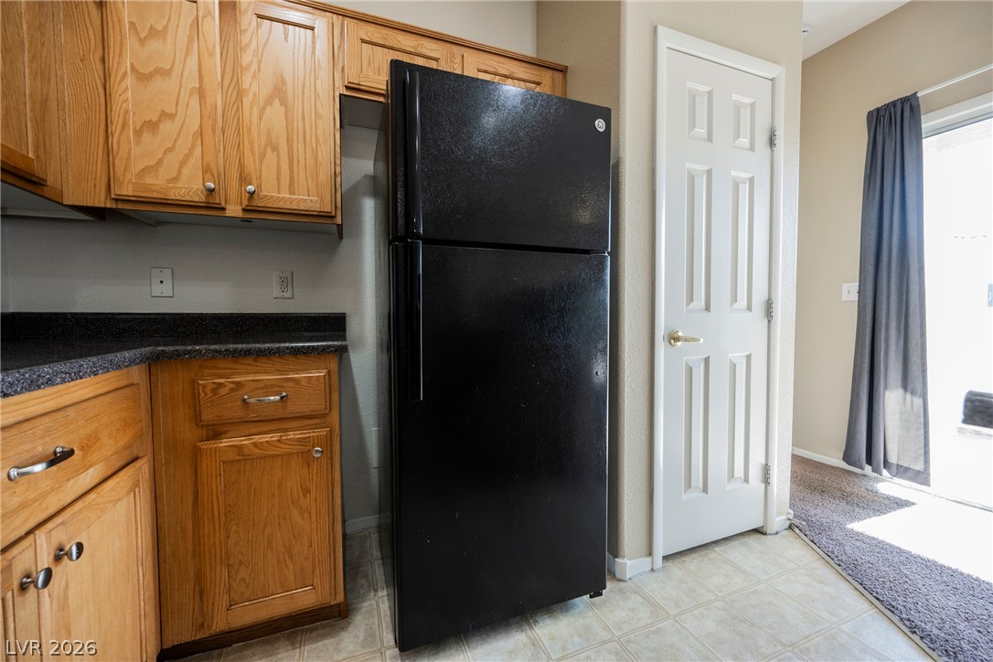 6320 Snap Ridge Street, Unit 201 North Las Vegas, NV 89081 - Photo 23 of 56 Functional kitchen with ample cabinetry and essential appliances for everyday living.